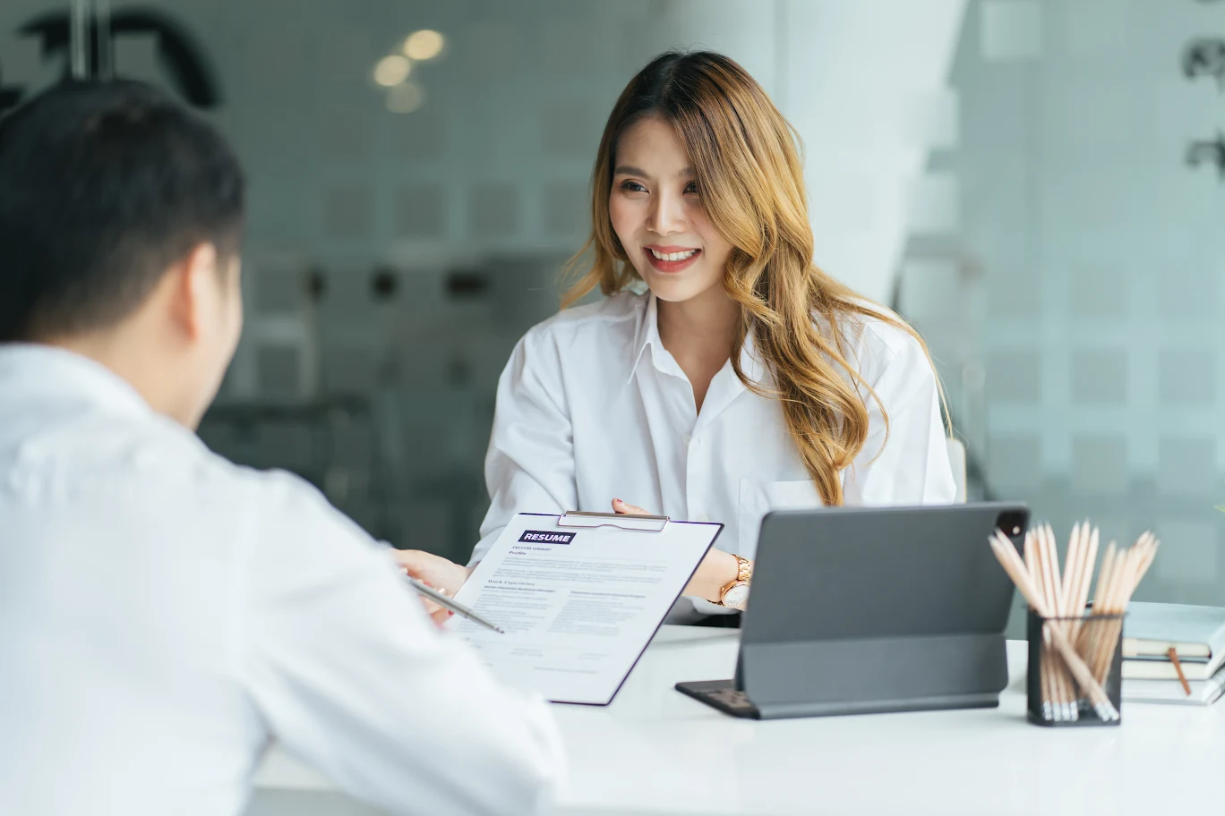 Two professionals discussing a resume across a desk